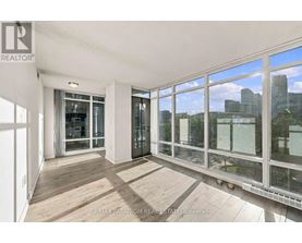 A room with a view of the city through large windows.