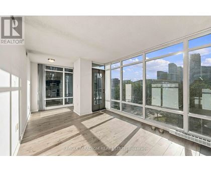 A room with a view of the city through large windows.