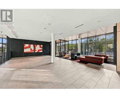 A large open space with a black wall and a red and white sign.