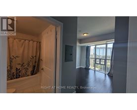 A bathroom with a shower and a door leading to a balcony.