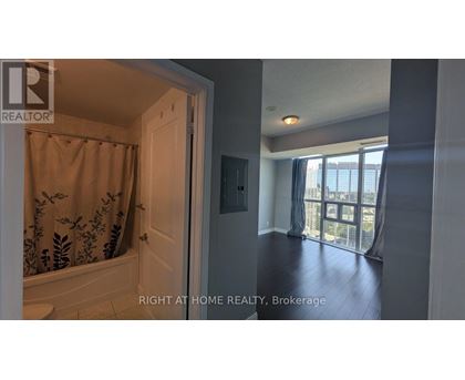 A bathroom with a shower and a door leading to a balcony.