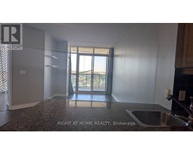 A room with a sink and a window overlooking a balcony.
