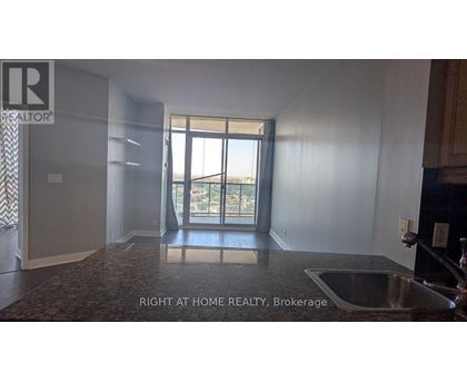 A room with a sink and a window overlooking a balcony.