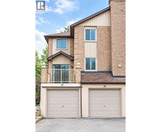 A two-story brick house with a balcony on the second floor.