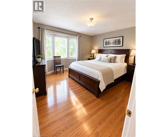 A bedroom with a large bed and a television.