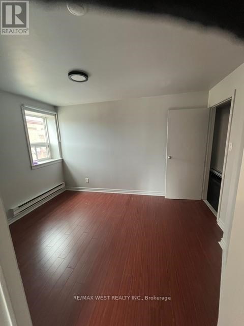 A room with a wooden floor and white walls.