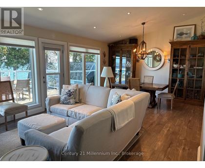 A living room with a white couch and a wooden cabinet.