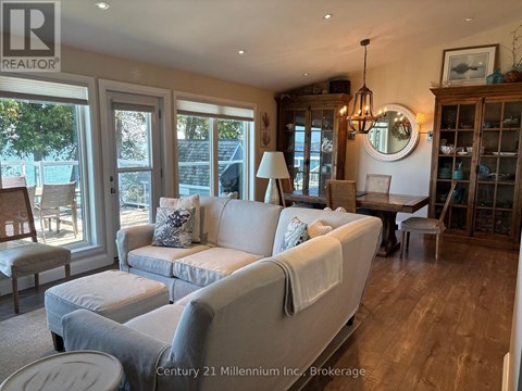A living room with a white couch and a wooden cabinet.