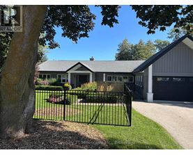 A house with a black fence in front of it.