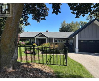 A house with a black fence in front of it.