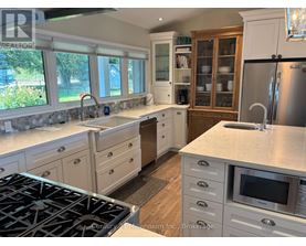 A kitchen with a stove top oven and a refrigerator.