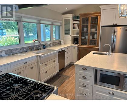 A kitchen with a stove top oven and a refrigerator.