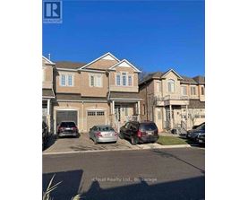 A row of houses with cars parked in front.