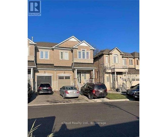 A row of houses with cars parked in front.