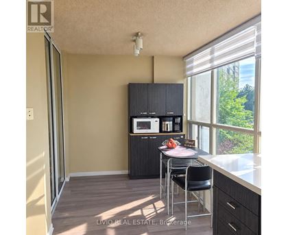 A kitchen with a microwave on the cabinet.