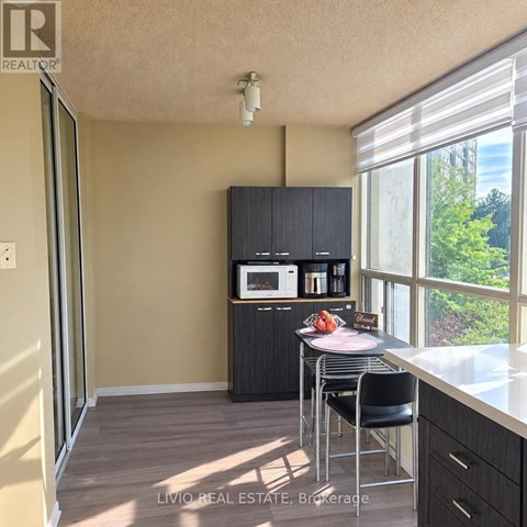 A kitchen with a microwave on the cabinet.