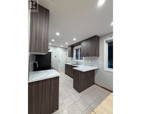 A modern bathroom with a large mirror and a double sink vanity.