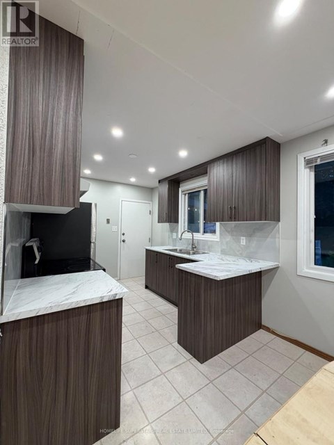 A modern bathroom with a large mirror and a double sink vanity.