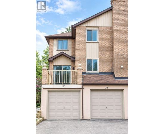 A two-story brick house with a balcony on the second floor.