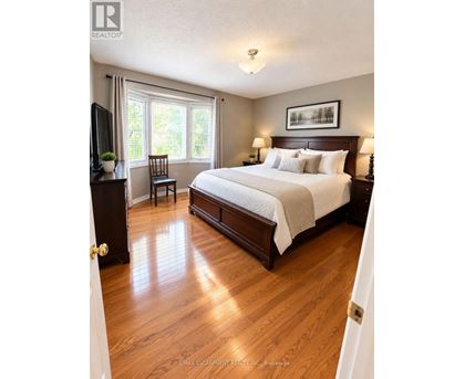 A bedroom with a large bed and a television.