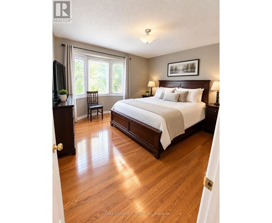 A bedroom with a large bed and a television.