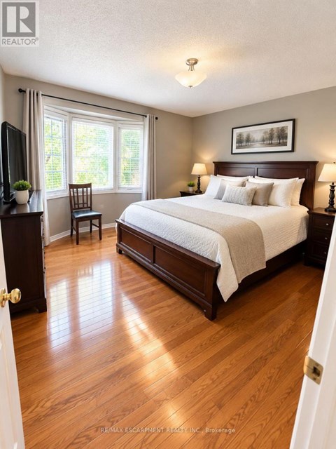 A bedroom with a large bed and a television.