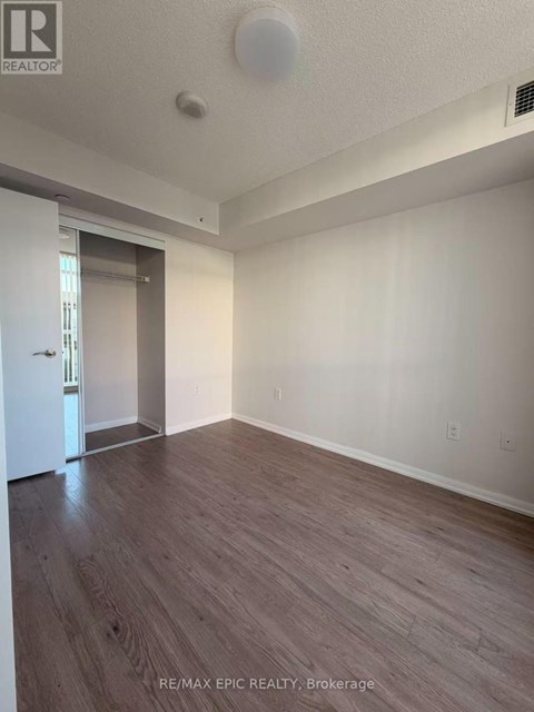 A room with wood flooring and a white ceiling.