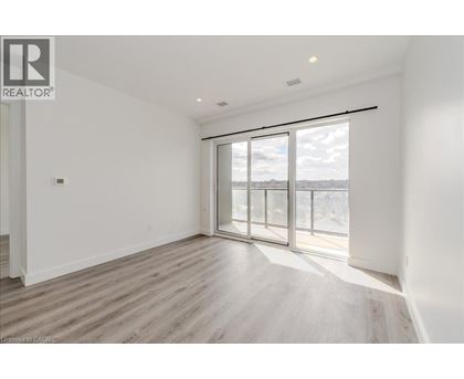 A spacious room with a large window and sliding glass doors.