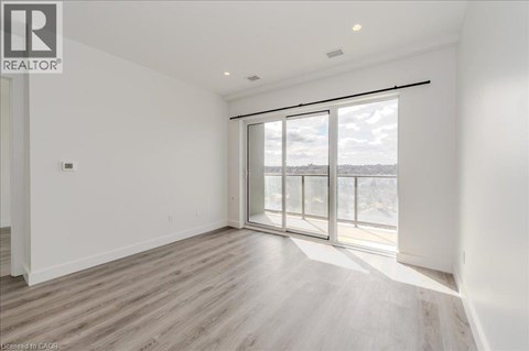 A spacious room with a large window and sliding glass doors.
