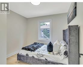 A bedroom with a bed and a window.
