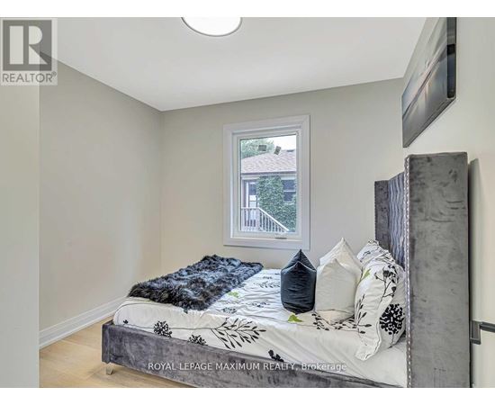 A bedroom with a bed and a window.