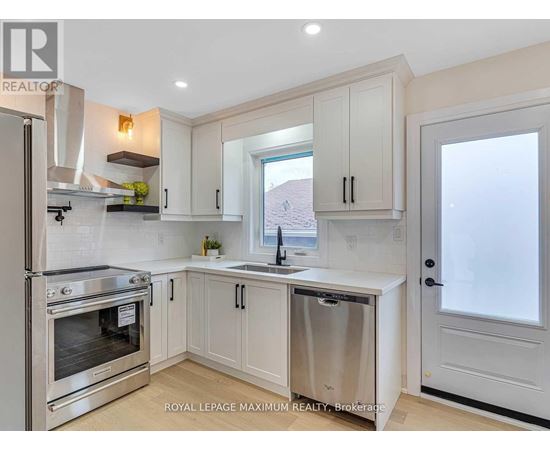 A kitchen with white cabinets and a stainless steel dishwasher.