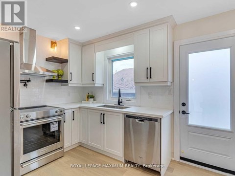 A kitchen with white cabinets and a stainless steel dishwasher.
