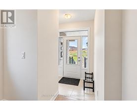 A white door with a glass window and a black mat in front of it.