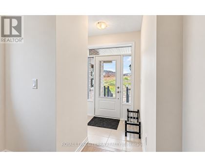 A white door with a glass window and a black mat in front of it.
