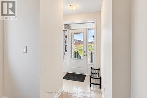 A white door with a glass window and a black mat in front of it.