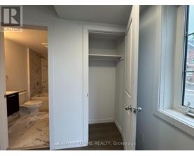 A bathroom with a toilet and a sink is shown.