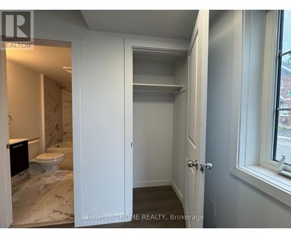 A bathroom with a toilet and a sink is shown.
