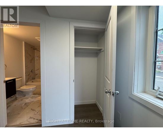 A bathroom with a toilet and a sink is shown.