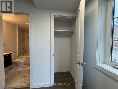 A bathroom with a toilet and a sink is shown.