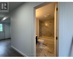 A bathroom with a toilet and a bathtub in a room that is under renovation.