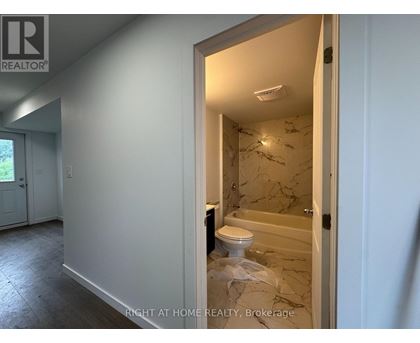 A bathroom with a toilet and a bathtub in a room that is under renovation.