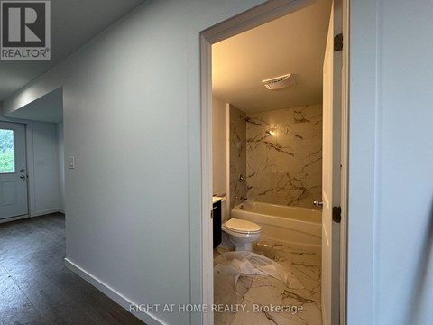 A bathroom with a toilet and a bathtub in a room that is under renovation.