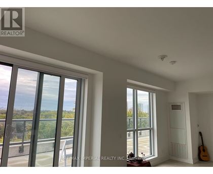 A room with a view of the outside through large windows.