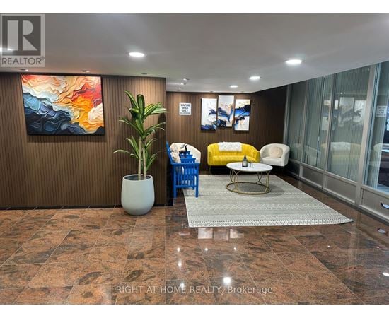 A living room with a brown wall and a painting on it.