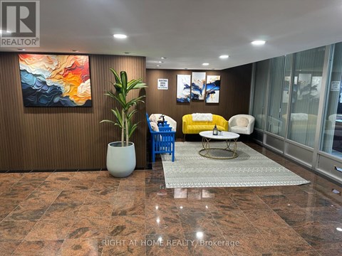 A living room with a brown wall and a painting on it.