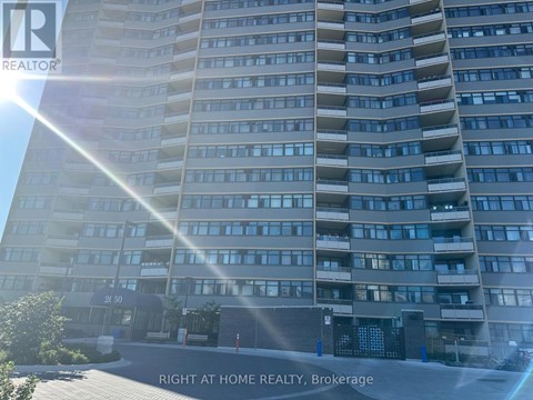 A tall residential building with the sun shining on it.