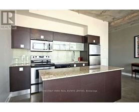 A kitchen with a stove top oven and a microwave above it.