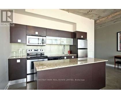 A kitchen with a stove top oven and a microwave above it.