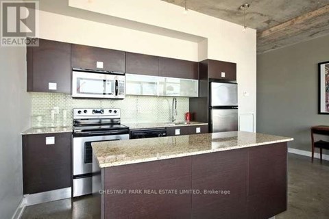 A kitchen with a stove top oven and a microwave above it.